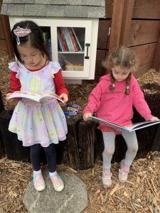 Reading in front of the Little Library